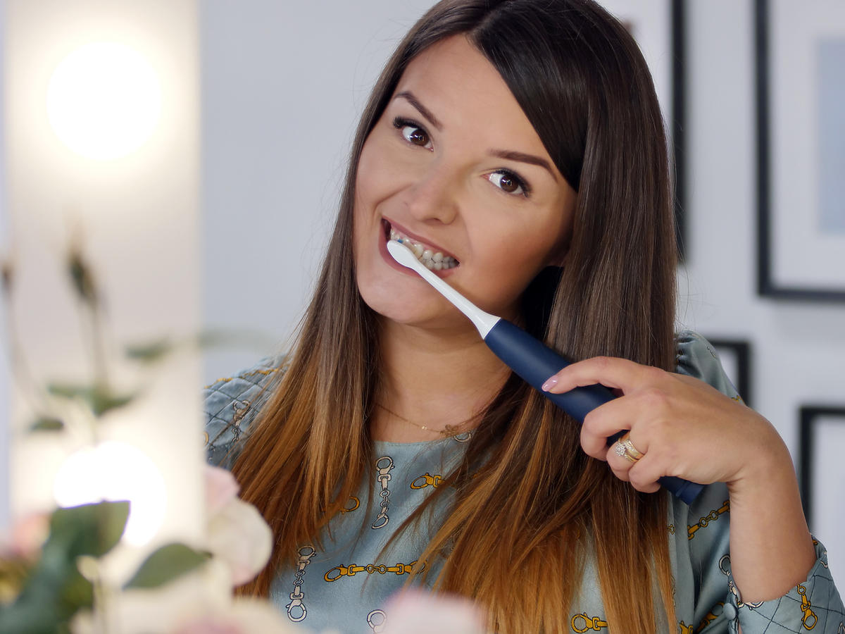 Dziewczyna myje zęby szczoteczką soniczną Protective Clean marki Philips